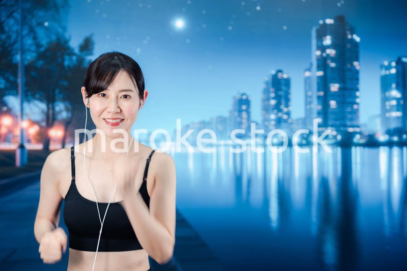 夜の街をランニングする女性