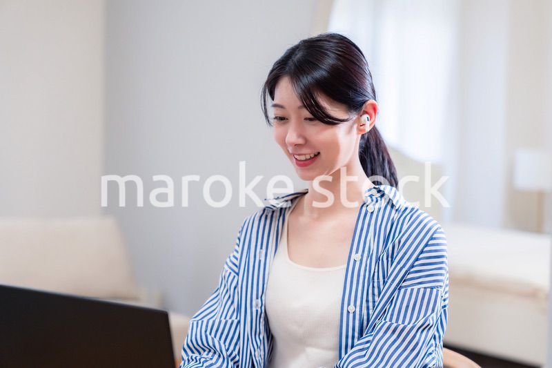 在宅でリモート会議に参加する若い女性社員