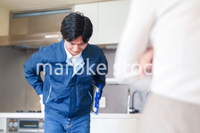 お客様に頭を下げてお詫びをする作業員の男性