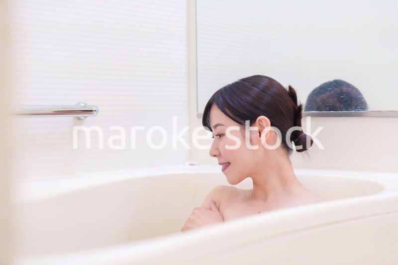家のお風呂に入ってゆっくりとリラックスをするミドルの女性