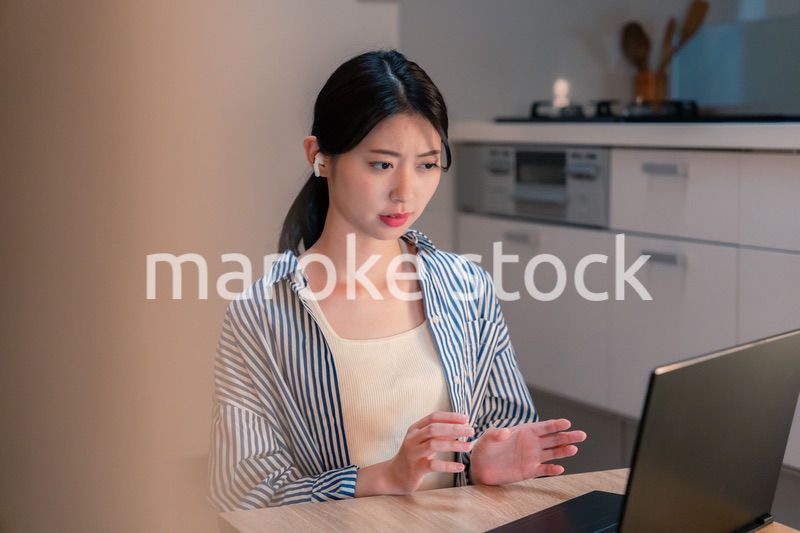 夜遅くにリモート会議をする若いビジネスパーソン