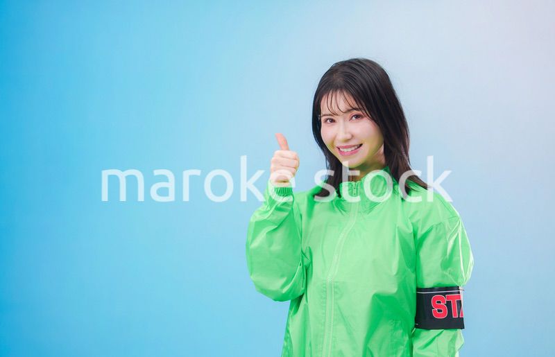 笑顔でお客様を案内するイベントスタッフ（水色背景）