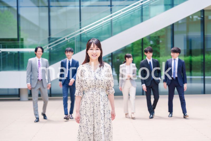 オフィスの外を笑顔で歩くキャリアウーマンと同僚