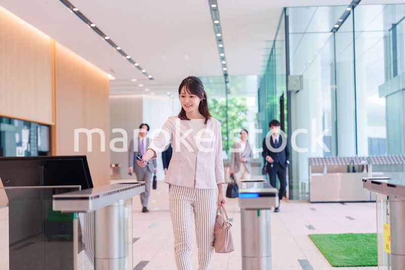 オフィスのセキュリティゲートを通るビジネスウーマン