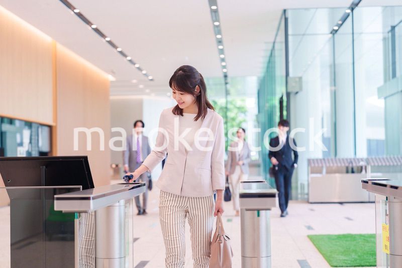 オフィスのセキュリティゲートを通るビジネスウーマン