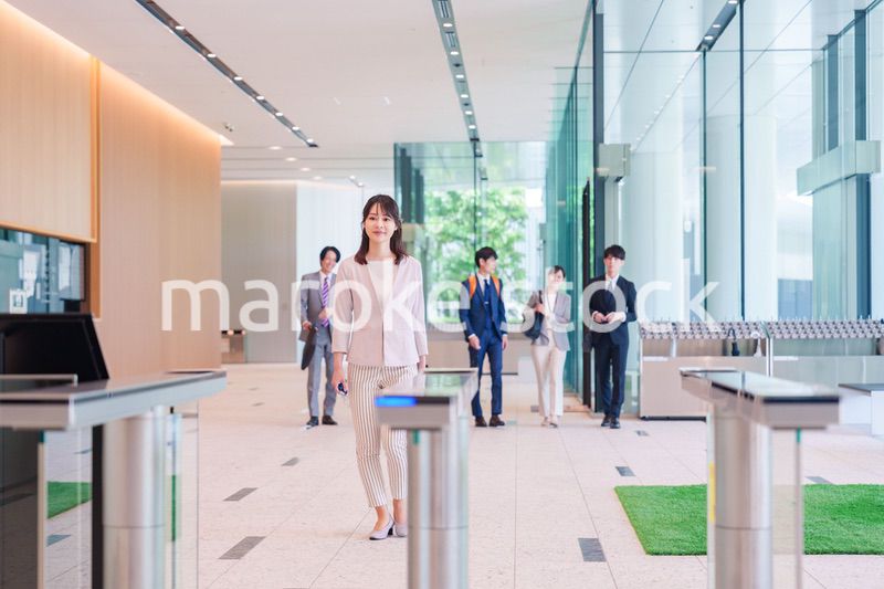 オフィスのセキュリティゲートを通るビジネスウーマン