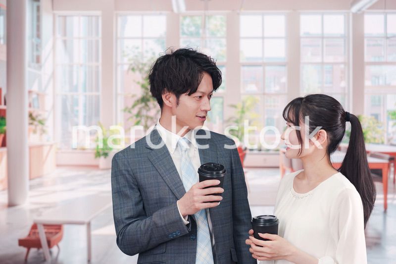 オフィスで話をする男女のビジネスパーソン