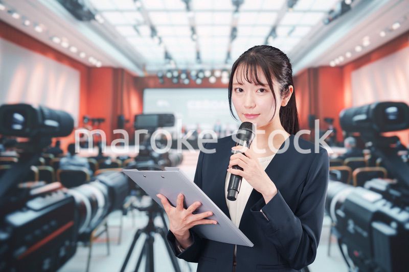 記者会見場からレポートをする女性のアナウンサー