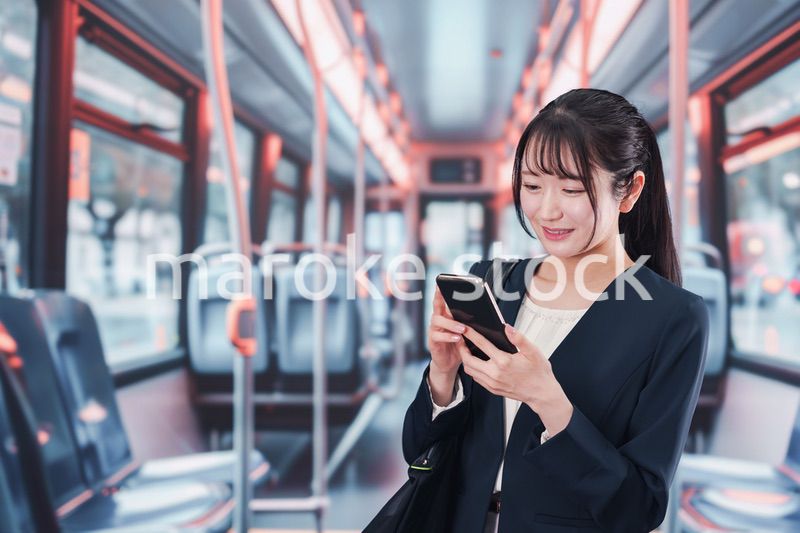 バスに乗って通勤をする若い女性