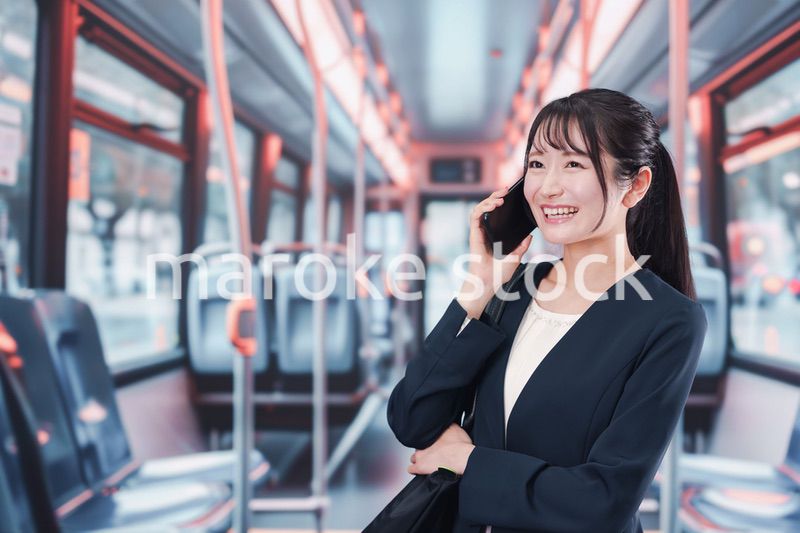 バスに乗って通勤をする若い女性