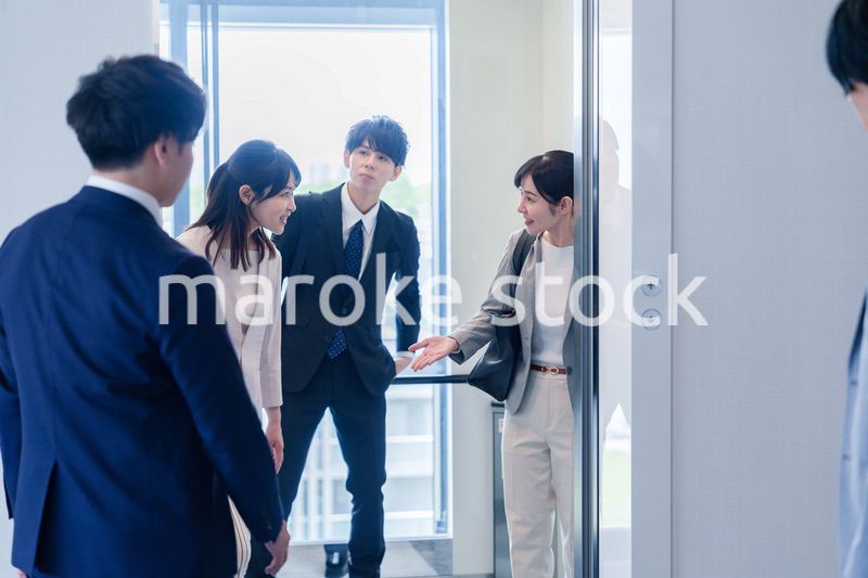 オフィスでエレベーターに乗るビジネスパーソン
