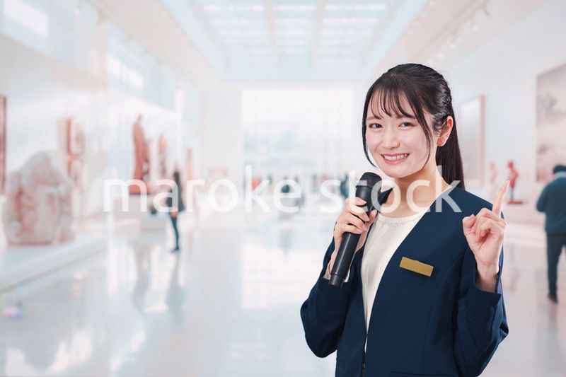 博物館で司会をする学芸員の女性