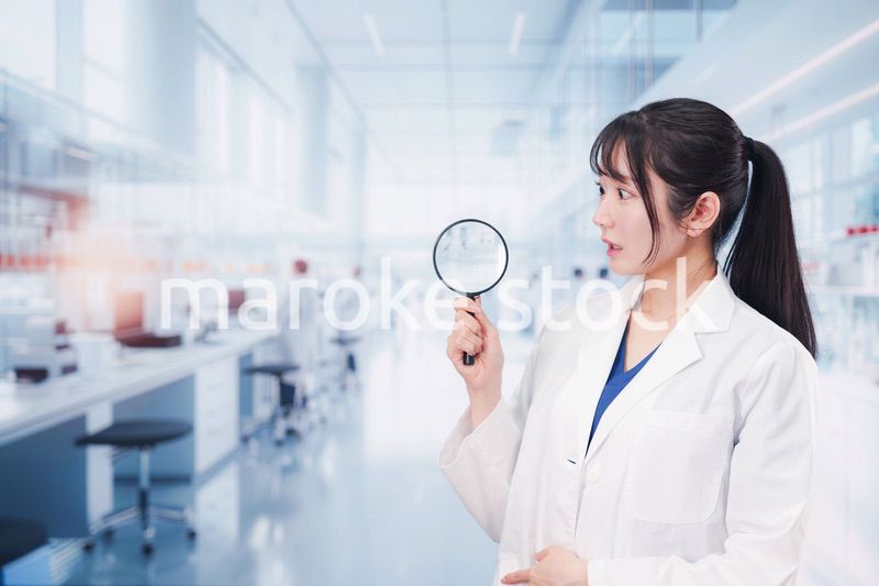 ルーペを持つ若い女性の研究者
