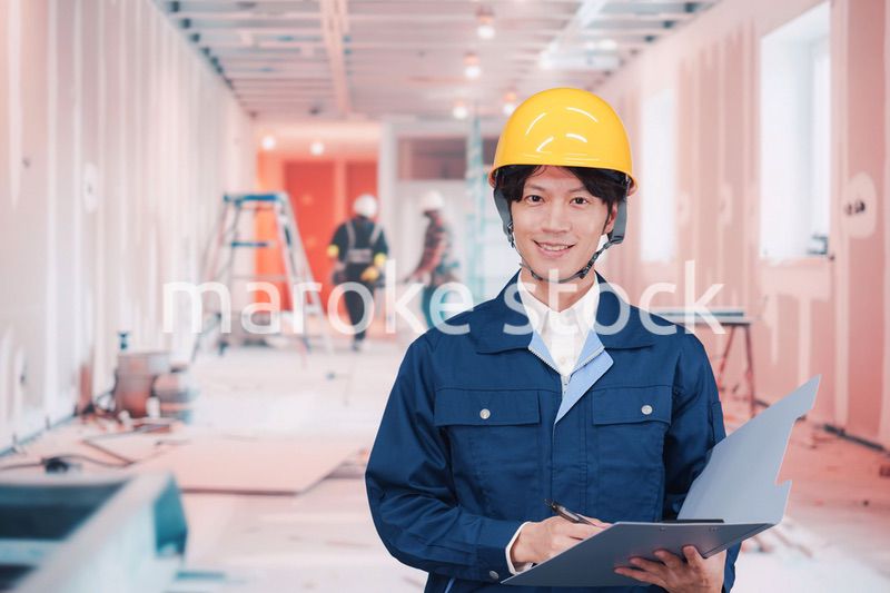 内装作業現場で働く若い作業員の男性