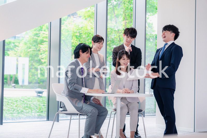 オフィスで笑顔で打ち合わせをするビジネスパーソン