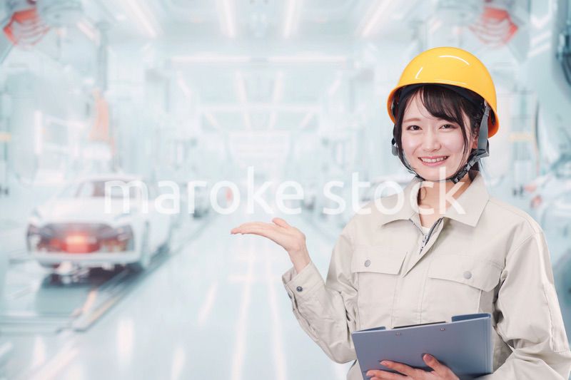 自動車工場の生産ラインで働く若い女性