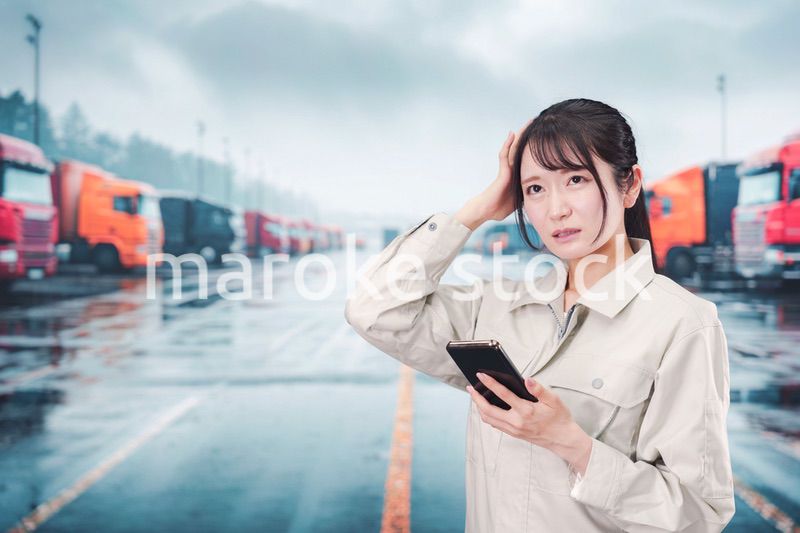 頭を抱えるトラックドライバーの女性