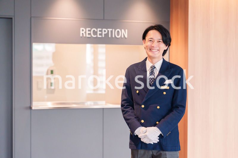 笑顔で接客をするホテルマンの男性
