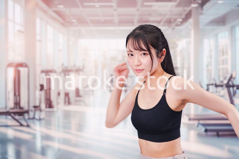 ジムでランニングをする若い女性