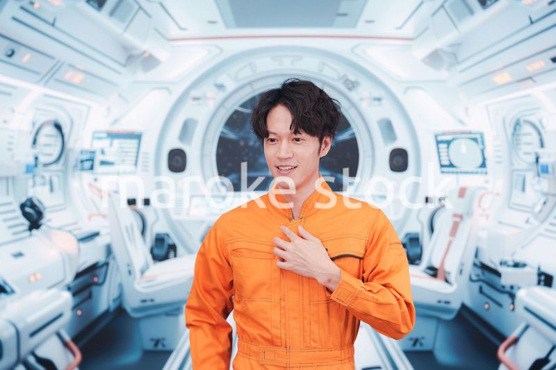 宇宙ステーションの中で働く若い男性の宇宙飛行士