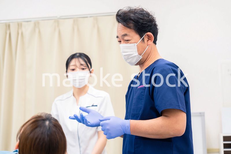 歯科治療をする歯医者の男性