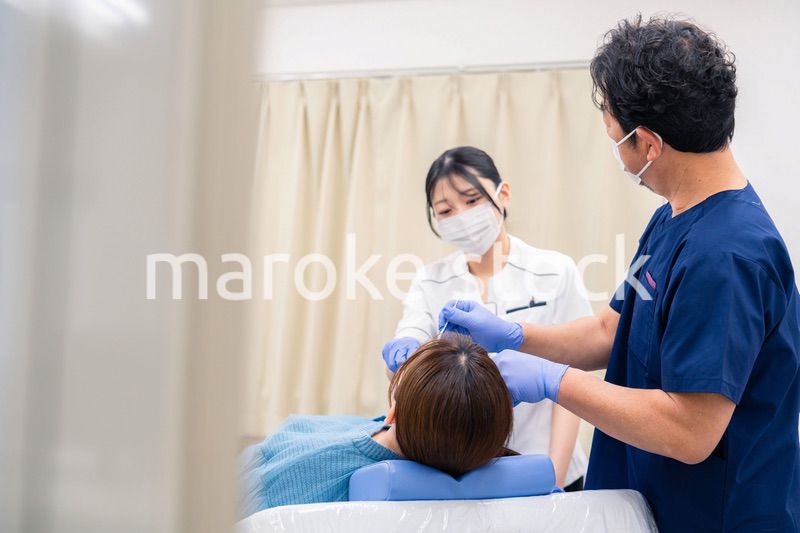 歯科治療をする歯医者の男性