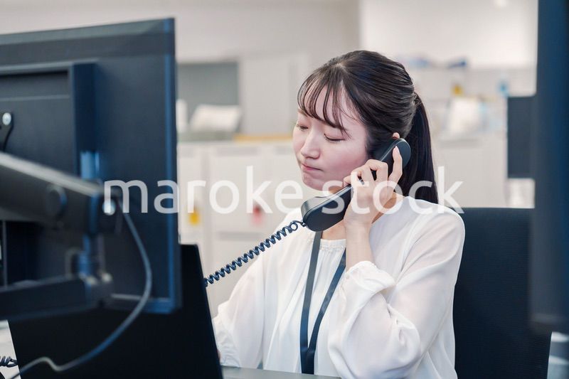 お客様からの電話に困惑をする若い女性オペレーター