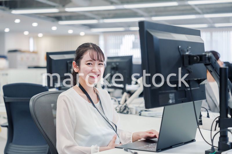 オフィスでデスクワークをする妊婦の女性