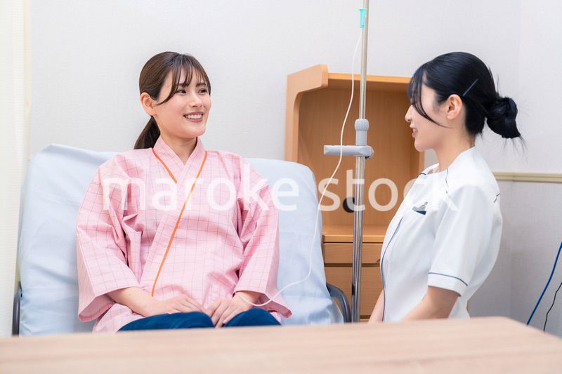 入院中の患者と話す医療従事者の女性