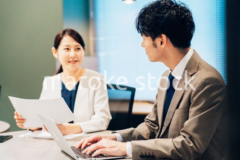 オフィスで打ち合わせをするミドルの女性