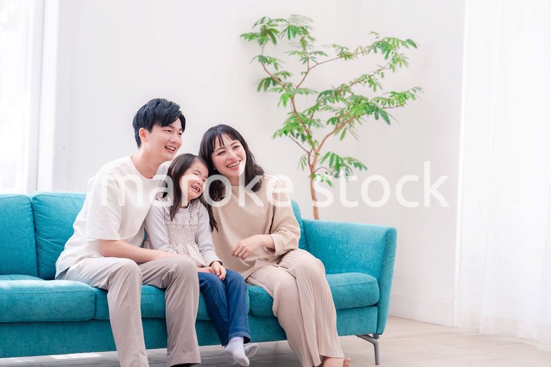 リビングでみんなでテレビを見るファミリー