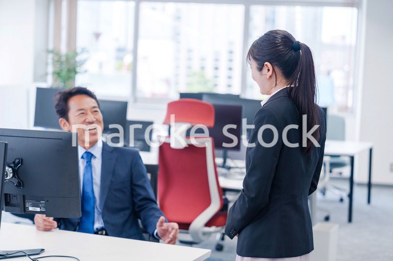 上司に挨拶をする新入社員の女性