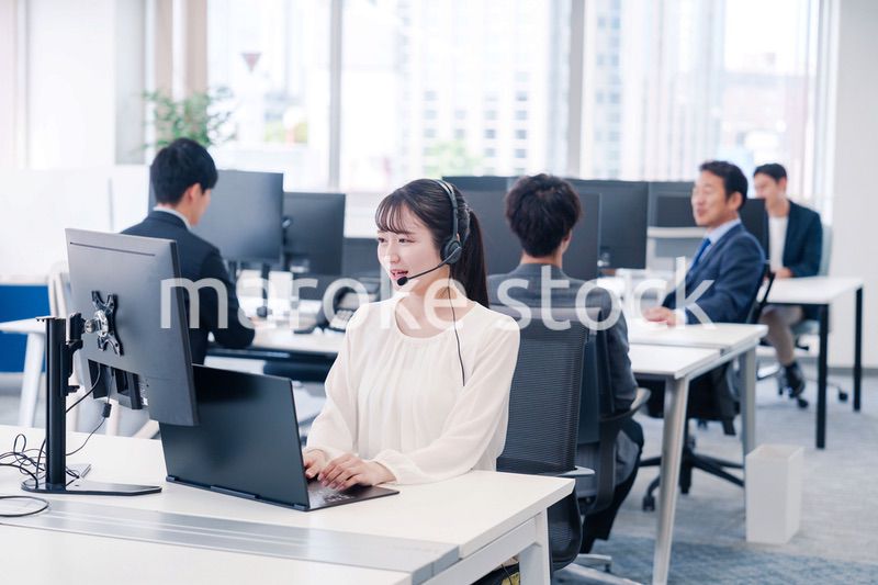 ヘッドセットをつけて話す若いビジネスウーマン