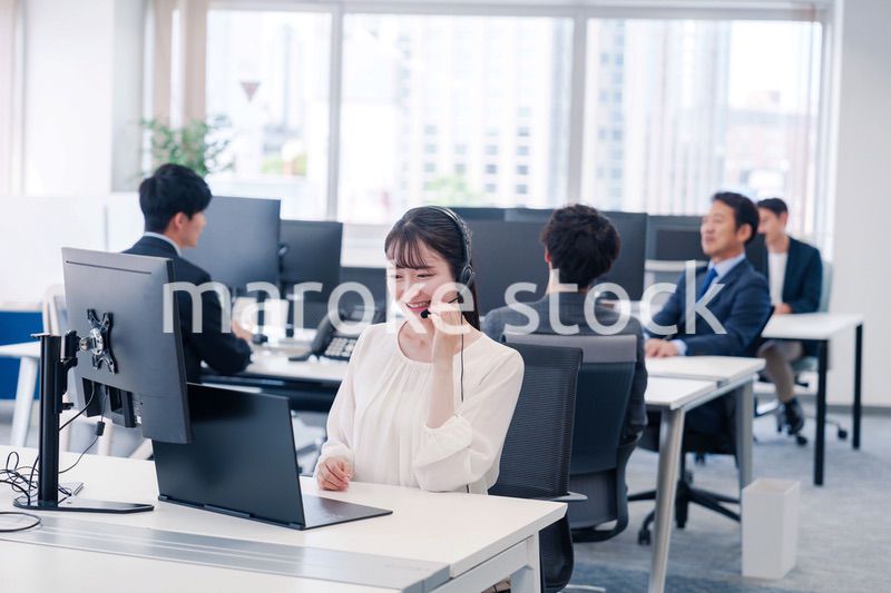 ヘッドセットをつけて話す若いビジネスウーマン