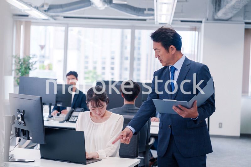 オフィスで上司から叱責をされる若い女性社員