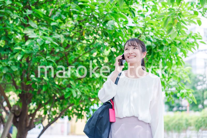 外で通話をする若い女性