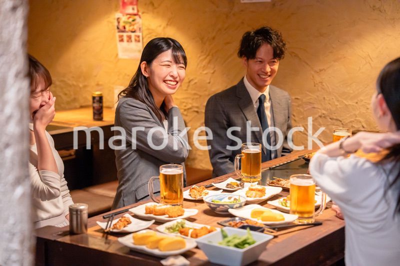 飲み会で大爆笑して盛り上がる会社員の女性