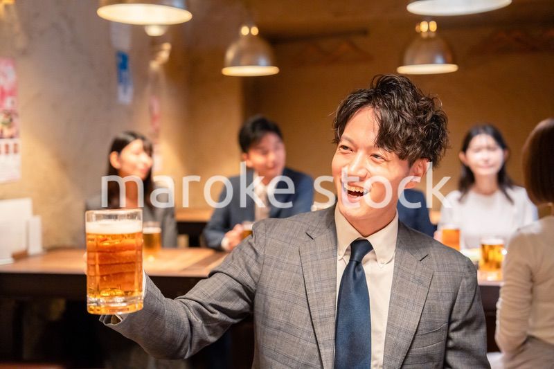 居酒屋でビールの乾杯をするサラリーマンの男性