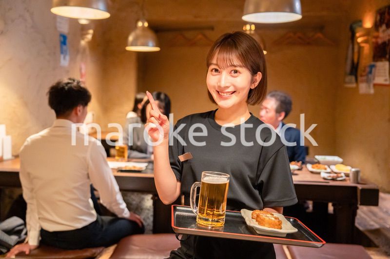 居酒屋のホールで働く若い女性
