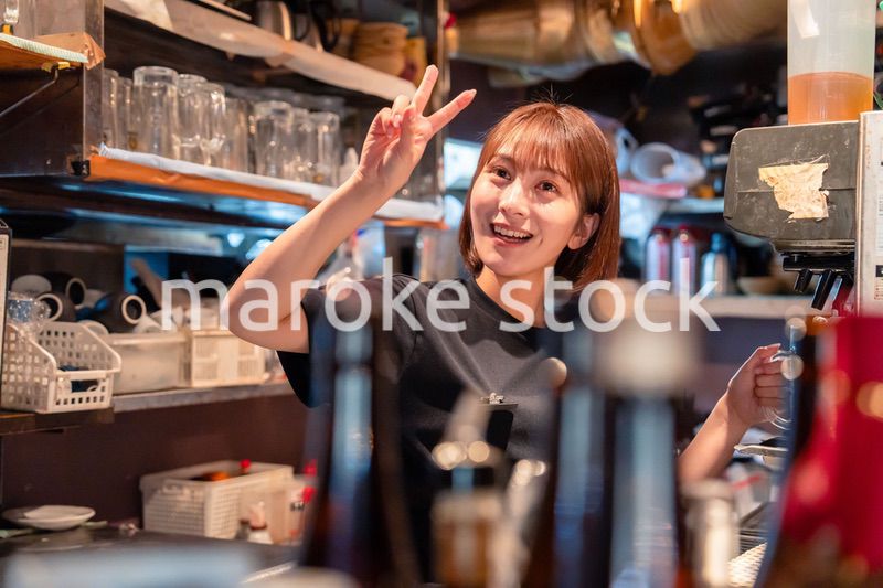 飲食店でビールサーバーを使う女性の店員