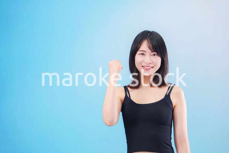 スポーツをする若い女性（水色背景）