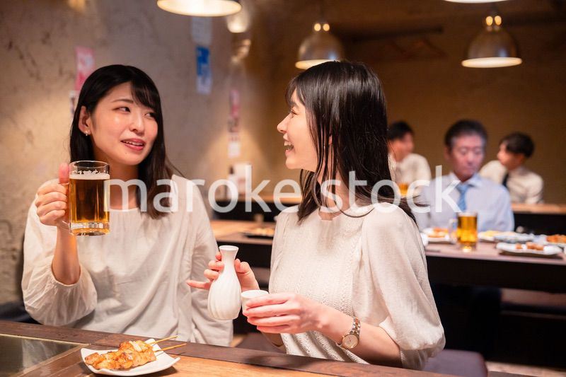 居酒屋で女子会をする二人の女性