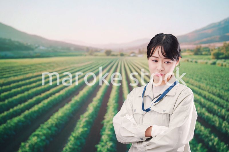 畑で悩む農家の若い女性