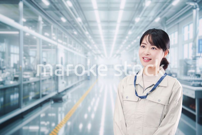 大きな工場で働く笑顔の若い女性