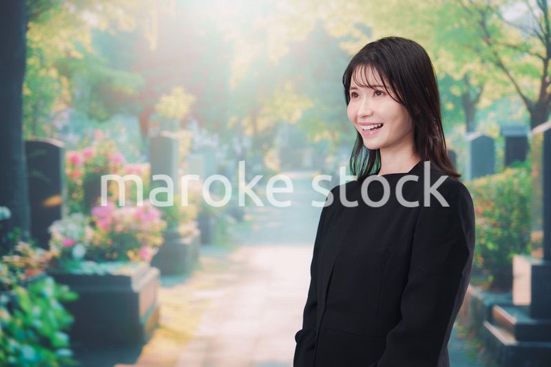 喪服を着てお墓参りをする女性