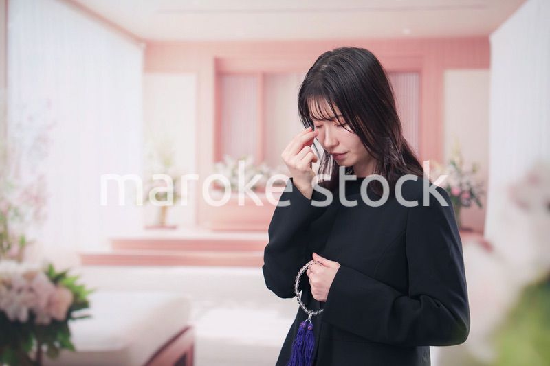 お葬式でお焼香をする女性の参列者