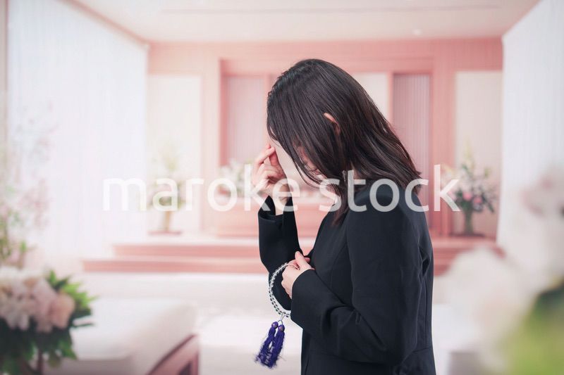 お葬式でお焼香をする女性の参列者