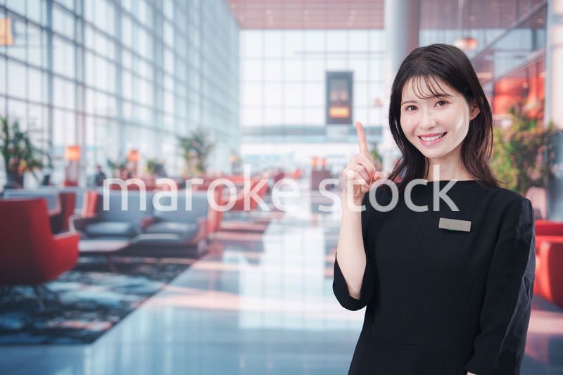 空港のラウンジで接客をする若い女性スタッフ