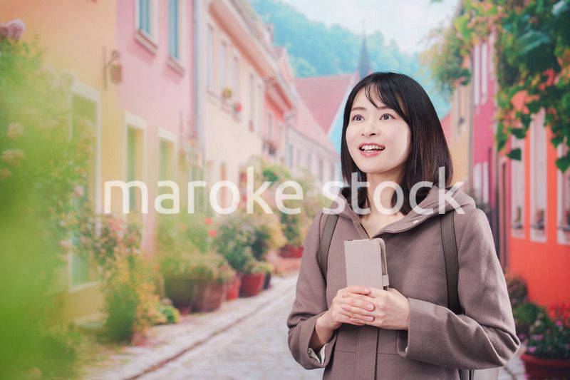 海外の街を一人で歩いて観光をする若い女性