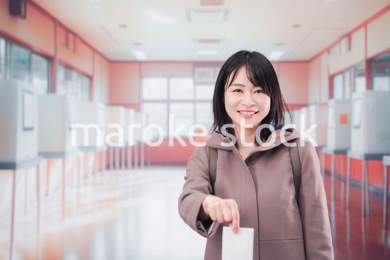 投票所で選挙の投票をする女性の有権者